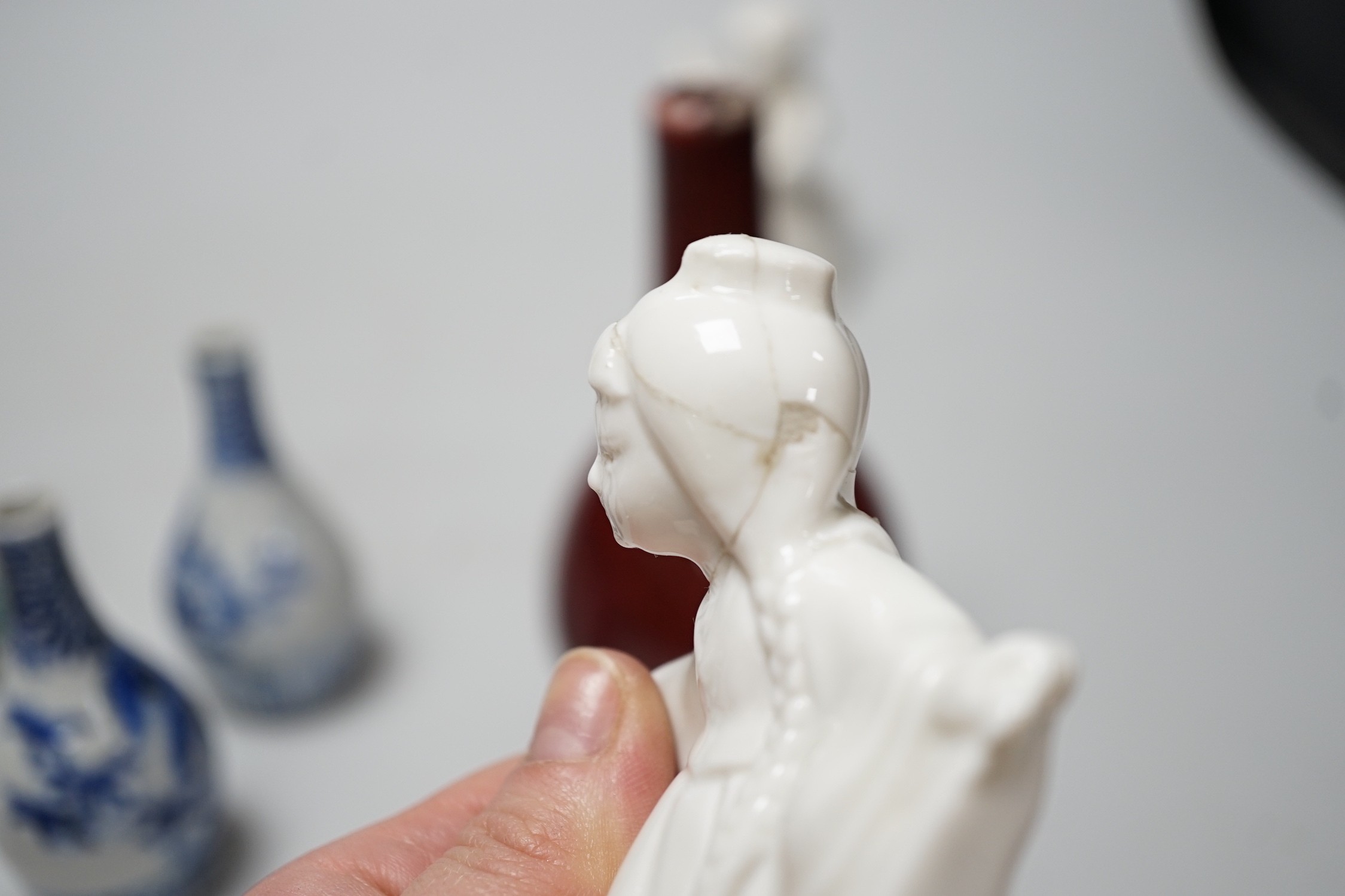 A Chinese sang de boeuf bottle neck vase, together with four Chinese miniature vases, three Chinese figures and a Chinese tea bowl, tallest 15cm